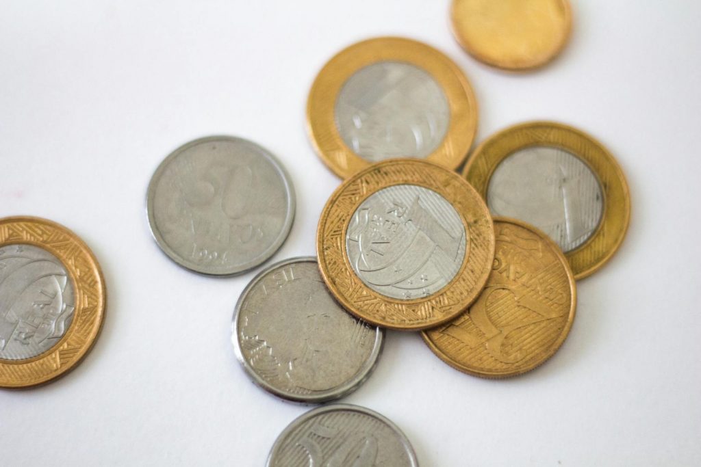 Silver and Gold Round Coins on White Surface